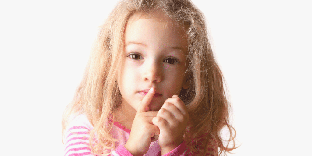 image of a small child holding her fingers over her lips seen and not heard
